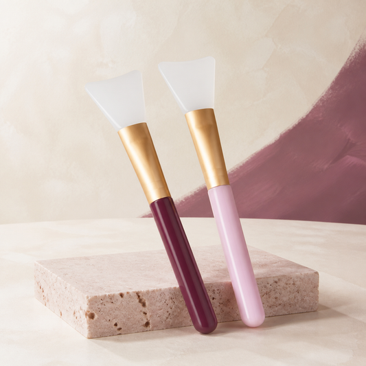 SmoothMask Applicator Duo photographed on a warm ivory and blush studio backdrop