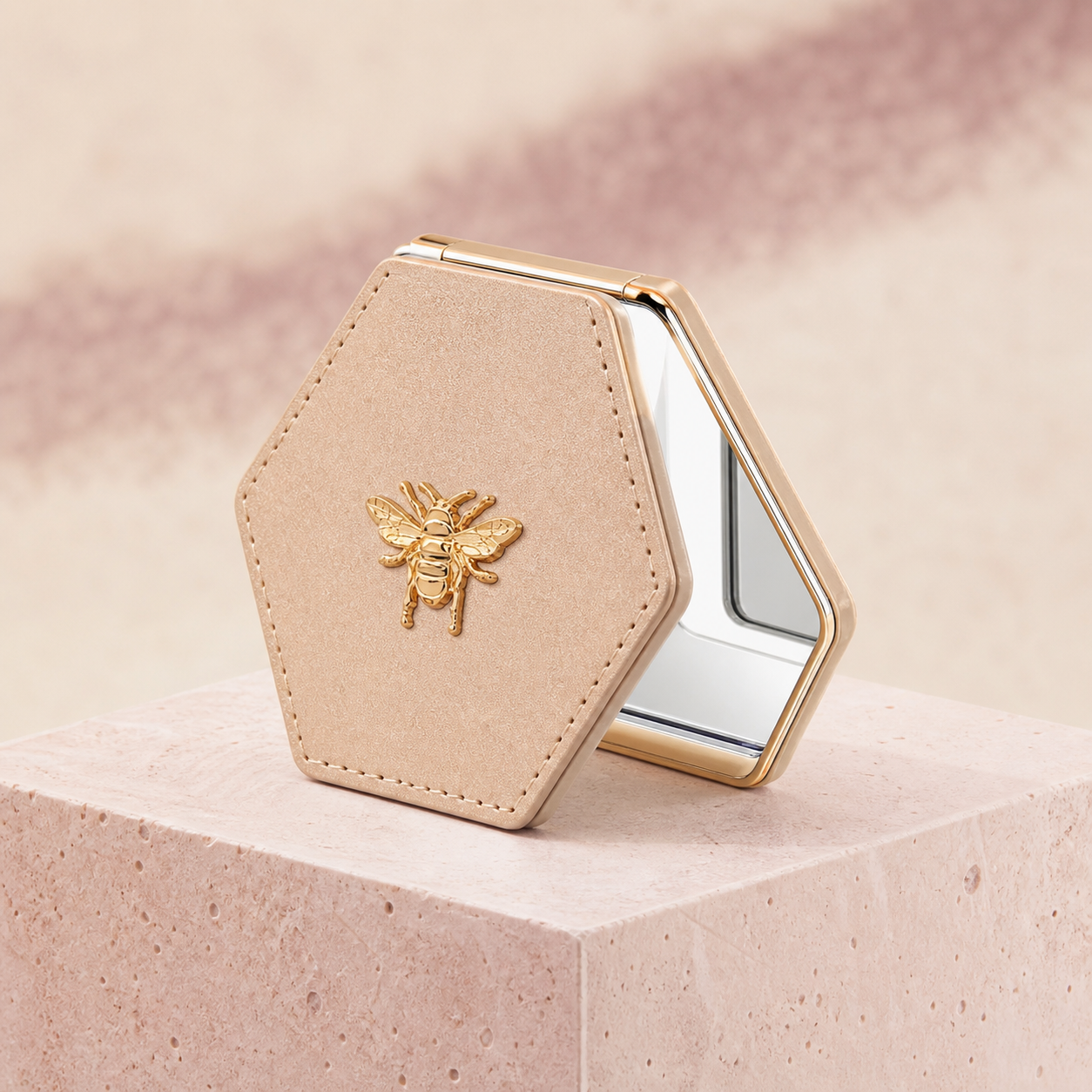 Bee Detail Folding Compact Mirror photographed on a warm ivory and blush studio backdrop